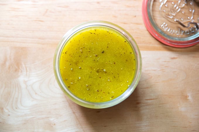 An overhead shot of a Weck jar filled with Italian dressing.