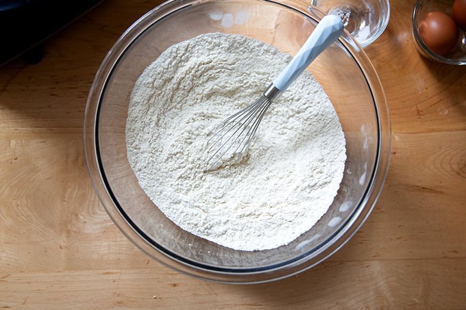 The dry ingredients to make chocolate chip cookies all whisked together in a large bowl.