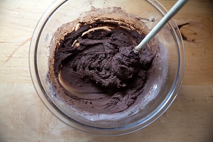 A bowl of chocolate crinkle cookie dough.