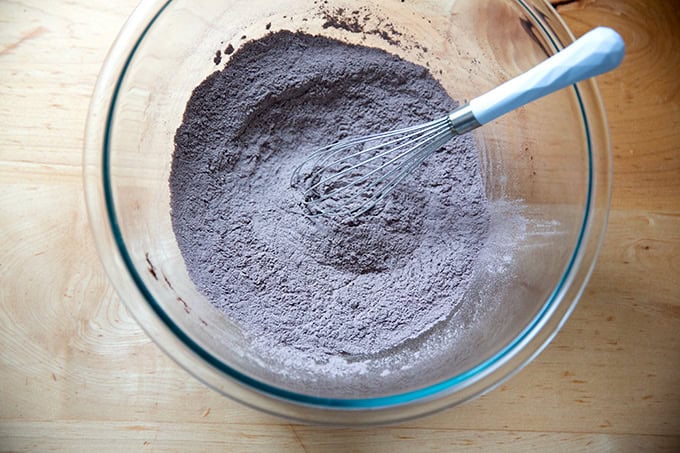 A bowl of whisked together flour, cocoa, salt and baking powder.
