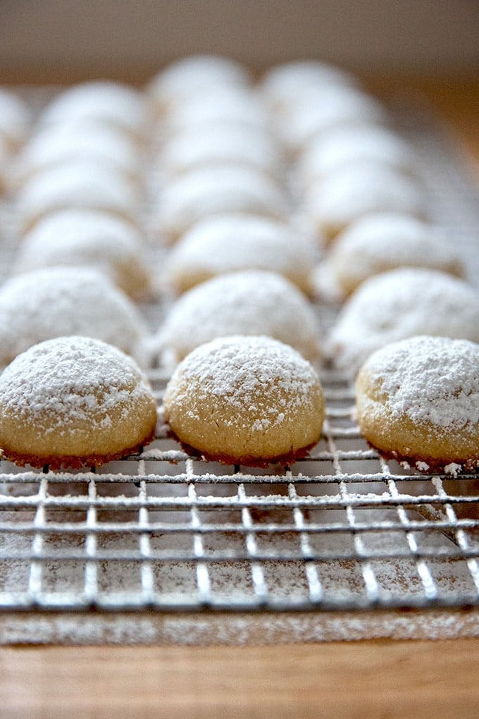 Lemon-almond snowball cookies cooling on a cooling rack.