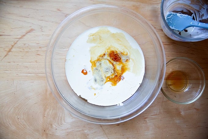 A bowl with heavy cream, vanilla, and eggs not yet whisked together.