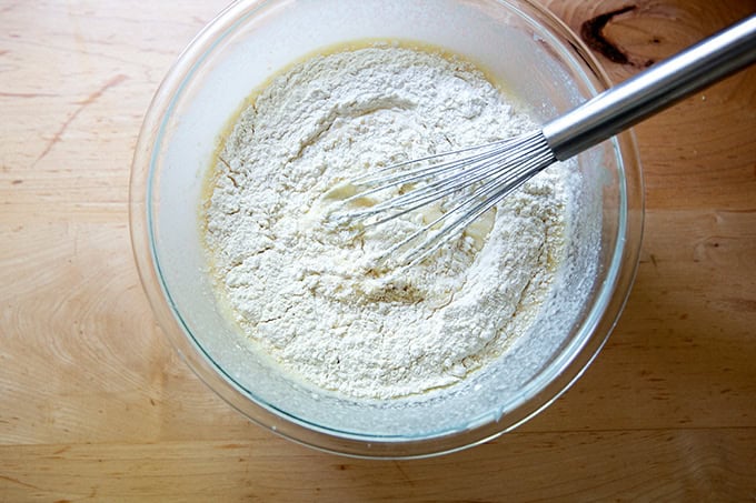 The dry ingredients for sourdough discard pancakes added to the wet ingredients in a large bowl.