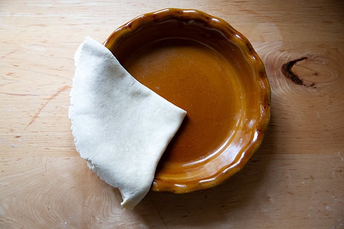 Folded pie dough in a pie plate.