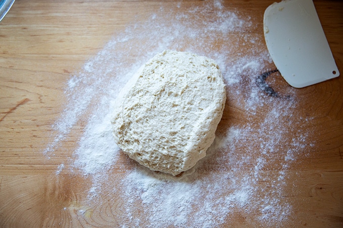 Turned out risen gluten-free pizza dough on a countertop.