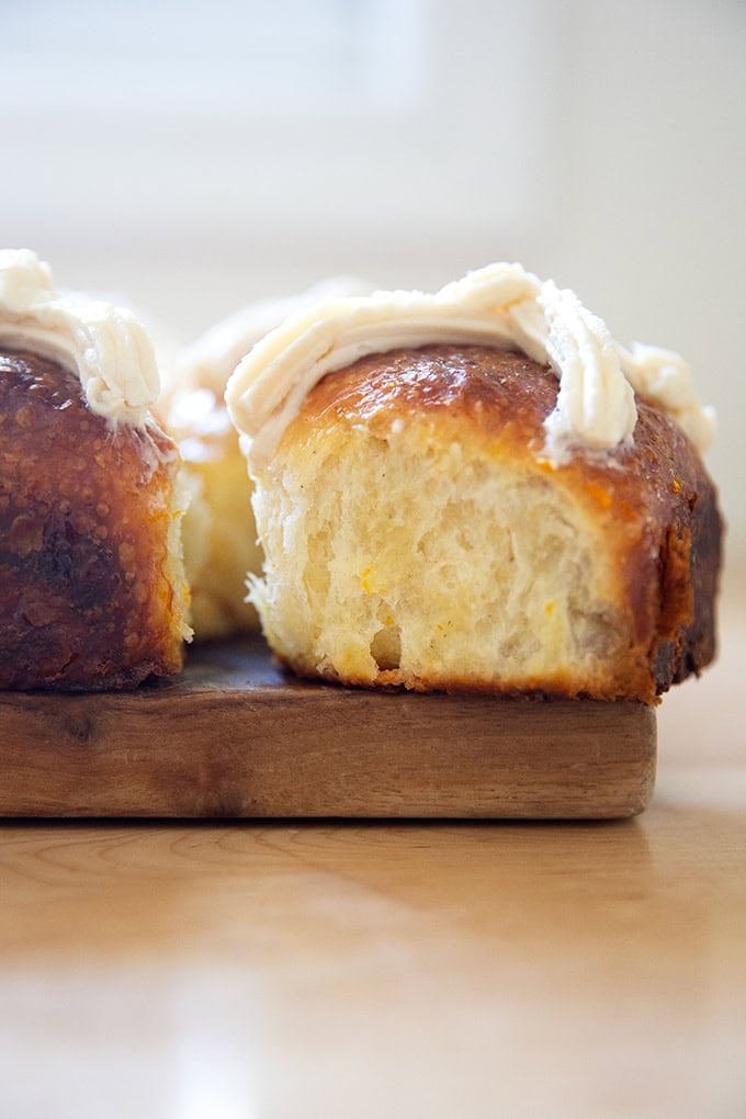 A side view of a just baked hot cross bun.