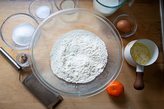 The ingredients to make hot cross buns on a countertop.