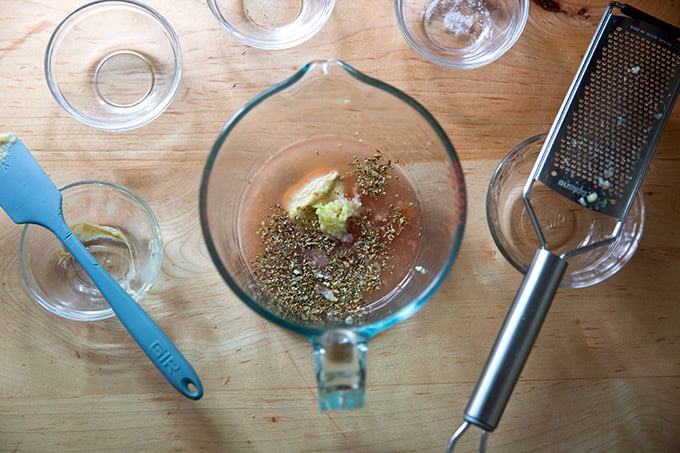 Italian dressing ingredients added to a 4-cup liquid measure.