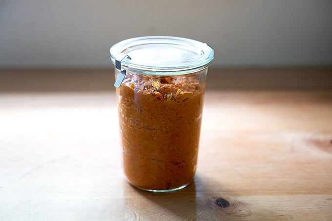 A glass Weck jar filled with homemade romesco sauce.
