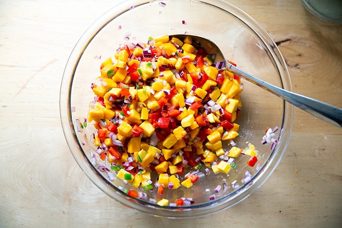 A large bowl of mango salsa without the cilantro added.