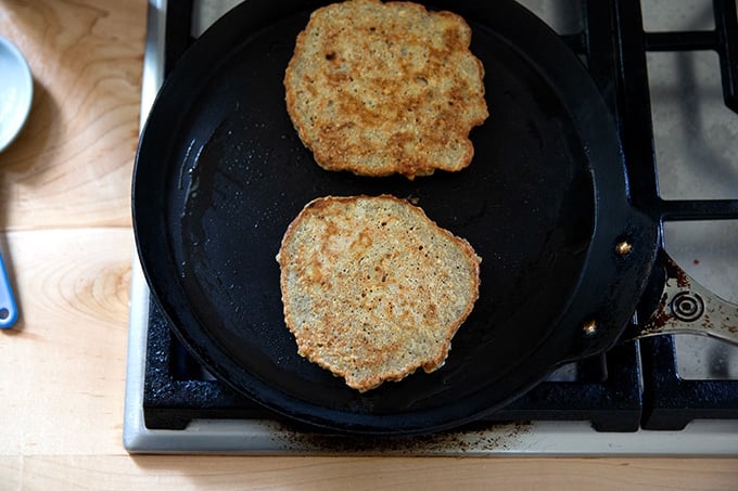 Banana-oat pancakes in a skillet.
