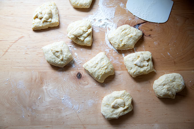 Nine portioned pieces of hot cross bun dough.
