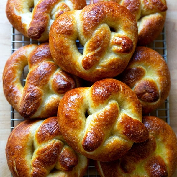 Just-baked soft pretzels on a cooling rack.