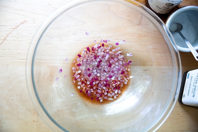 Red onions macerating in vinegar and lemon juice.
