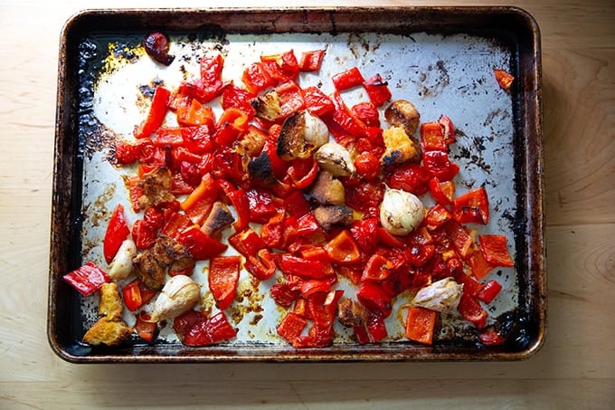 Roasted vegetables for romesco sauce on a sheet pan.