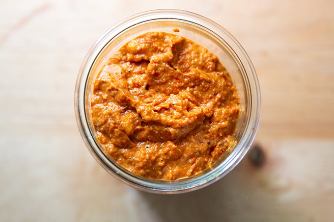 Homemade romesco sauce in a glass jar.