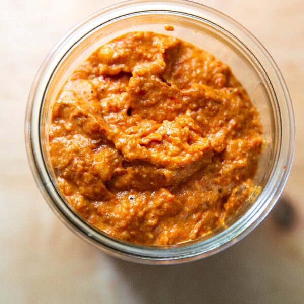 Homemade romesco sauce in a glass jar.