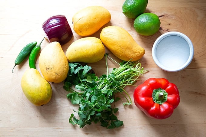 The ingredients to make mango salsa on a counter top.