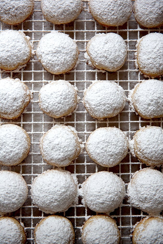 Lemon-almond snowball cookies cooling on a cooling rack.