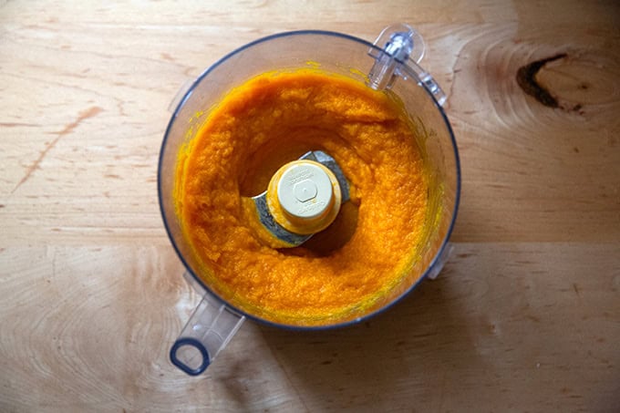 A food processor filled with puréed roasted butternut squash.