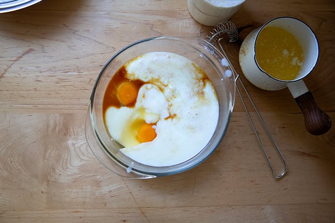 The wet ingredients to make sourdough discard waffles on a countertop.