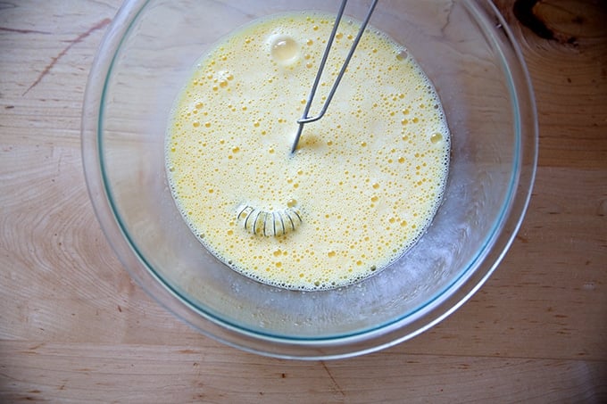 A bowl of beaten eggs, 1/2 and 1/2, and salt.