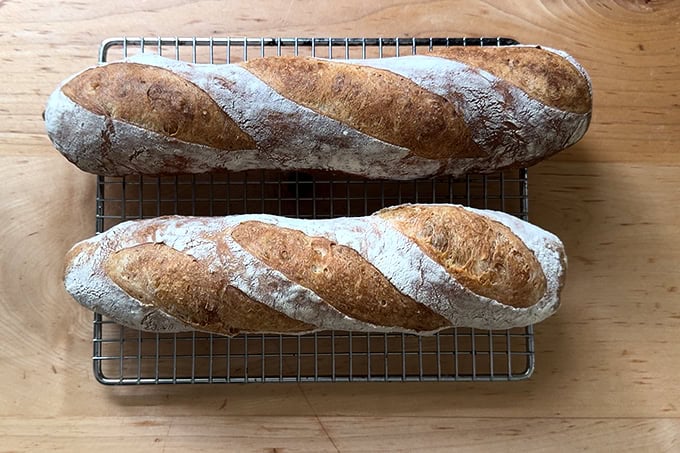 Two baguettes baked in an oven without steam.