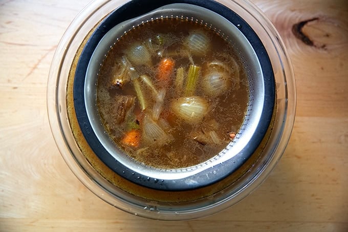 Strained turkey stock in a bowl.