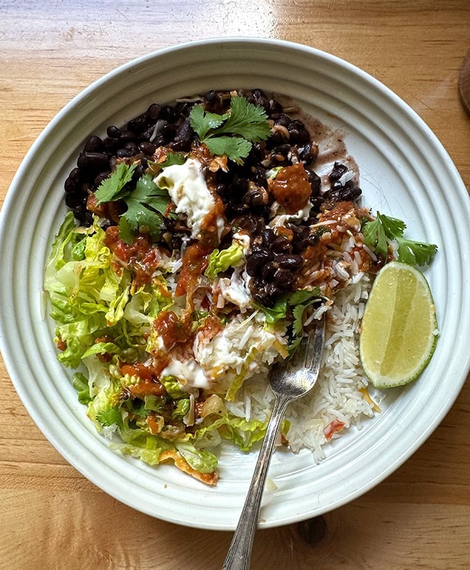 A rice and bean bowl with charred tomato salsa.