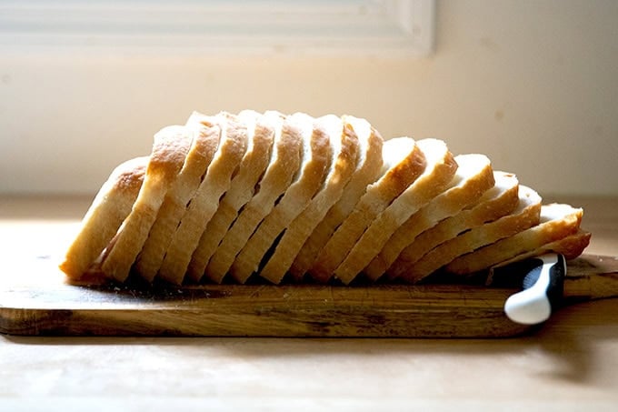 Sliced sourdough discard toasting bread on a cutting board.