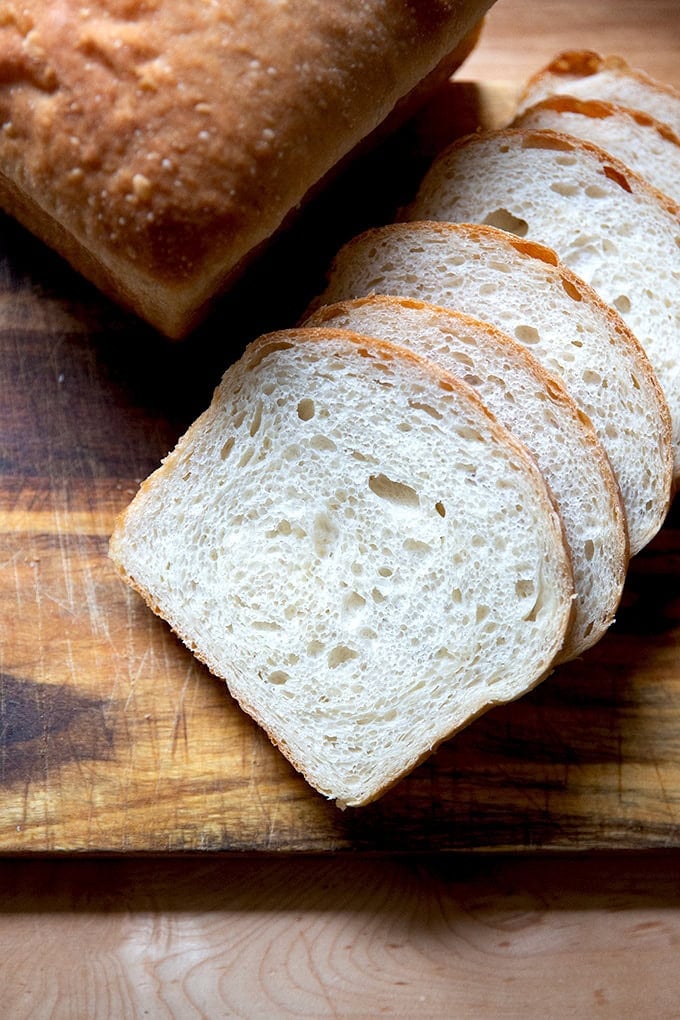 Sliced sourdough discard toasting bread on a cutting board.