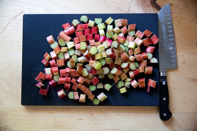 A cutting board topped with sliced rhubarb.