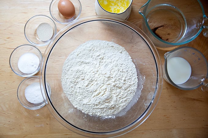 The ingredients to make brioche hot dog buns on a countertop.