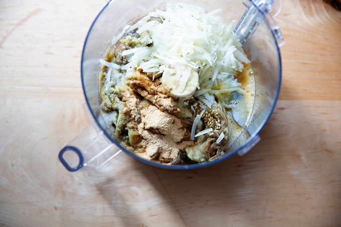 The ingredients to make eggplant meatballs in a food processor.