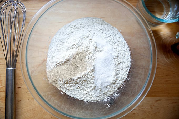 A bowl filled with flour, salt, and yeast for focaccia.