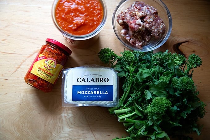 Topping ingredients for a grandma-style pizza on a countertop.