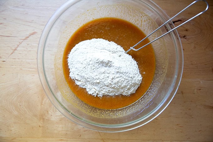 Flour added to the pumpkin muffin batter.