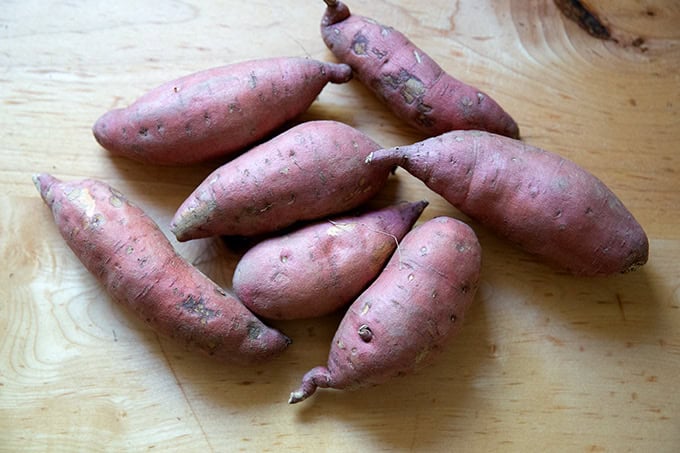 Two pounds of sweet potatoes on a counter top.