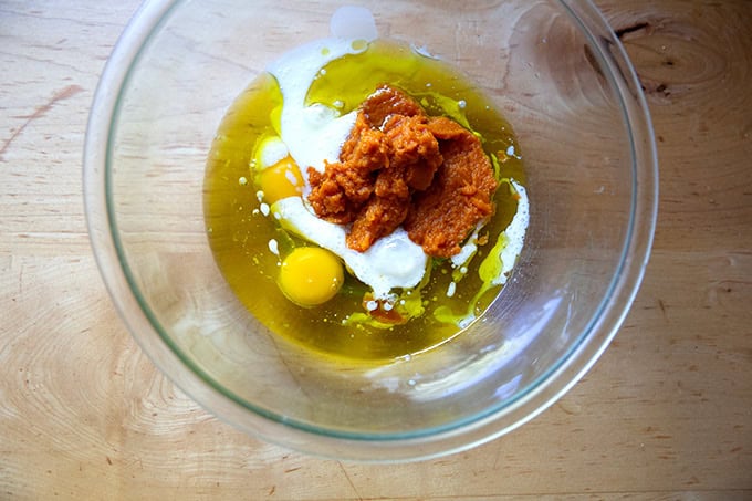 The wet ingredients to make pumpkin muffins in a large bowl.