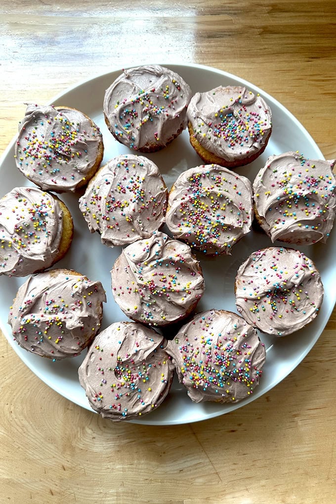 Vanilla cupcakes with chocolate whipped cream cheese frosting.