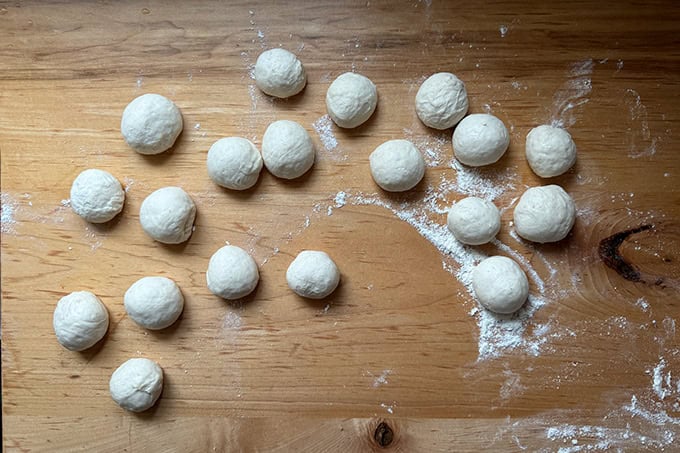 Monkey bread dough, portioned and balled up on a counter top.