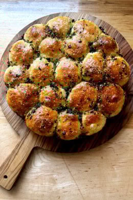 Just baked garlic-herb monkey bread on a cutting board.