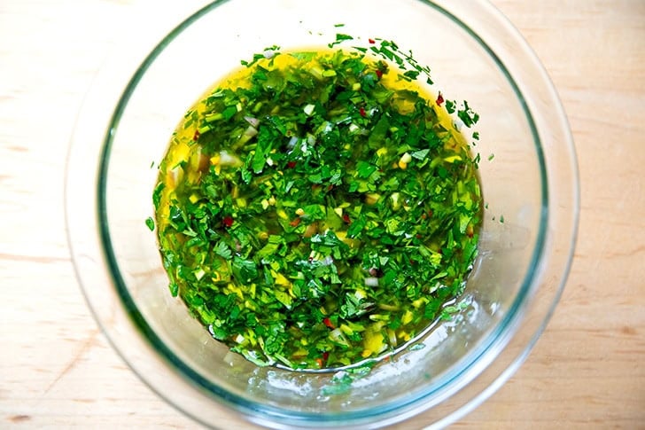 A bowl of stirred together chimichurri.