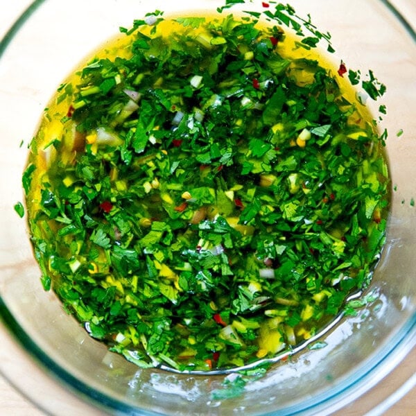 A bowl of stirred together chimichurri.