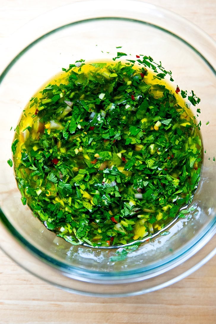 A bowl of stirred together chimichurri.